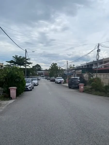 Exterior features: residential street view, lined with parked cars, overhead power lines, sidewalks, greenery along the road, street lighting, curbside trash bins.