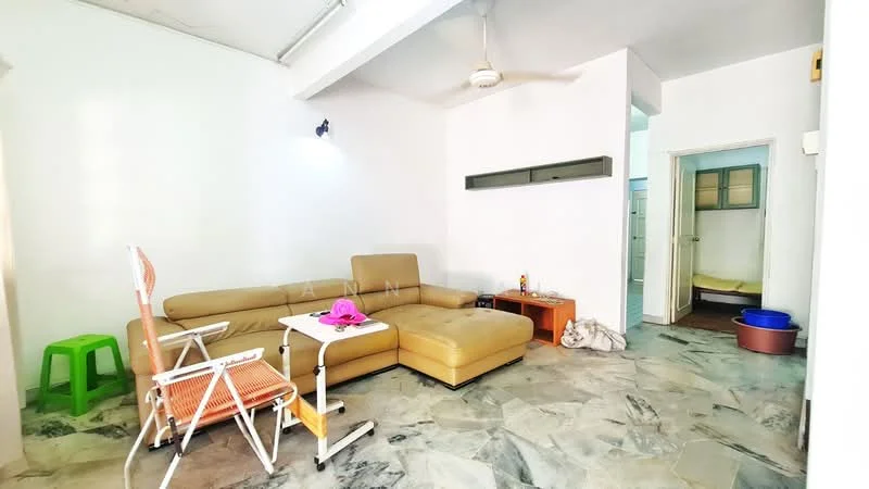 Living features: cream painted walls, marble flooring, 5-blade ceiling fan, L-shape sectional sofa in beige, coffee table, green plastic chair, wall-mounted shelf, doorway leading to other rooms.