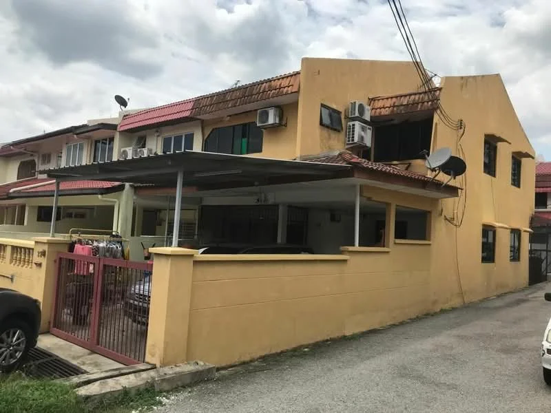 Exterior type: linked terrace house; features: yellow painted facade, flat roof, single-storey, car porch with awning, visible air conditioning units, satellite dish, manicured lawn, fenced perimeter, driveway with interlocking pavers; style: traditional.