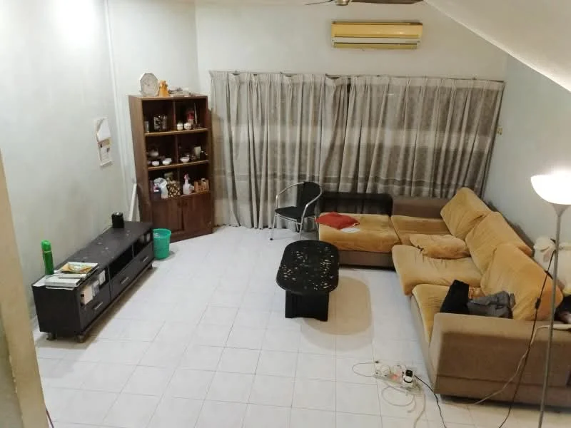 Living features: cream painted walls, white tiled flooring, 5-blade ceiling fan, wall-mounted air conditioning unit, L-shape sectional sofa in beige, coffee table, TV console, freestanding bookshelf, decorative items on shelves, curtains with striped pattern, floor lamp, green trash bin, visible electrical cords.