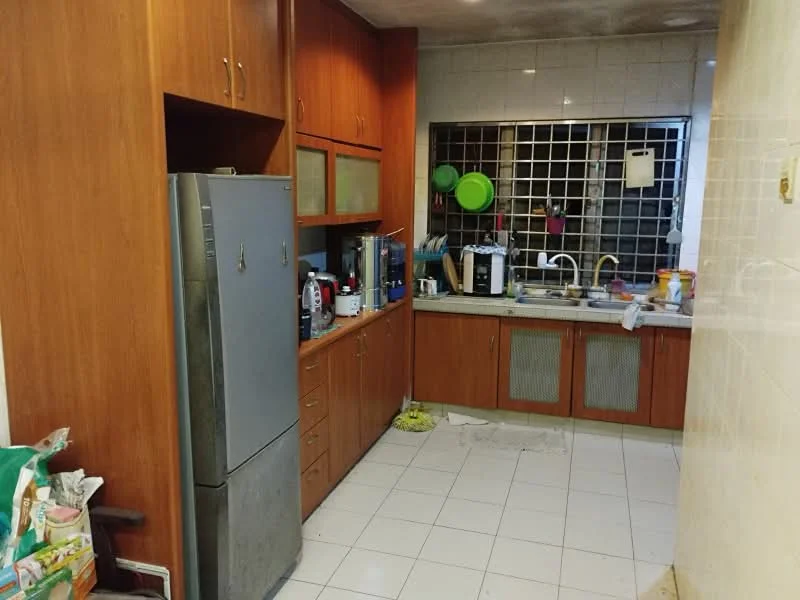 Kitchen features: wooden cabinetry, stainless-steel fridge, double-bowl stainless-steel sink, chrome pull-down faucet, ceramic tile flooring, white tiled walls, countertop with backsplash, window with metal grille, kitchen appliances visible, cleaning supplies on floor.
