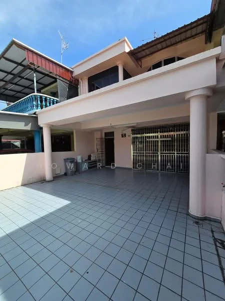 Exterior type: linked terrace house; features: pink painted facade, flat roof, ground floor terrace, tiled flooring, metal railing on upper balcony, covered porch area, grill gate at entrance, outdoor space with ample room for parking, surrounded by neighboring houses; style: modern.