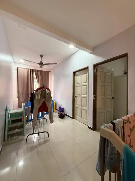 Room features: light-colored painted walls, tiled flooring, ceiling fan, two wooden doors, curtains on window, clothes rack, children's play area with chairs, clothes hanging on railing; style: modern.