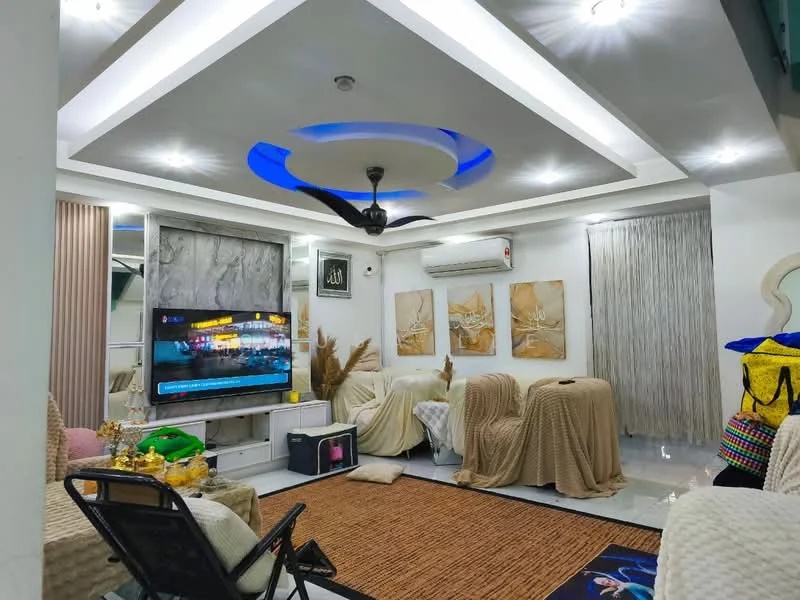 Living features: sofa covered with throw blankets, 3-seater fabric sofa in cream, area rug with geometric pattern, wall-mounted TV, TV console, ceiling fan with integrated LED light, recessed downlights, decorative wall art, white painted walls, grey accent wall, sliding curtains, marble flooring, decorative plants; style: modern.