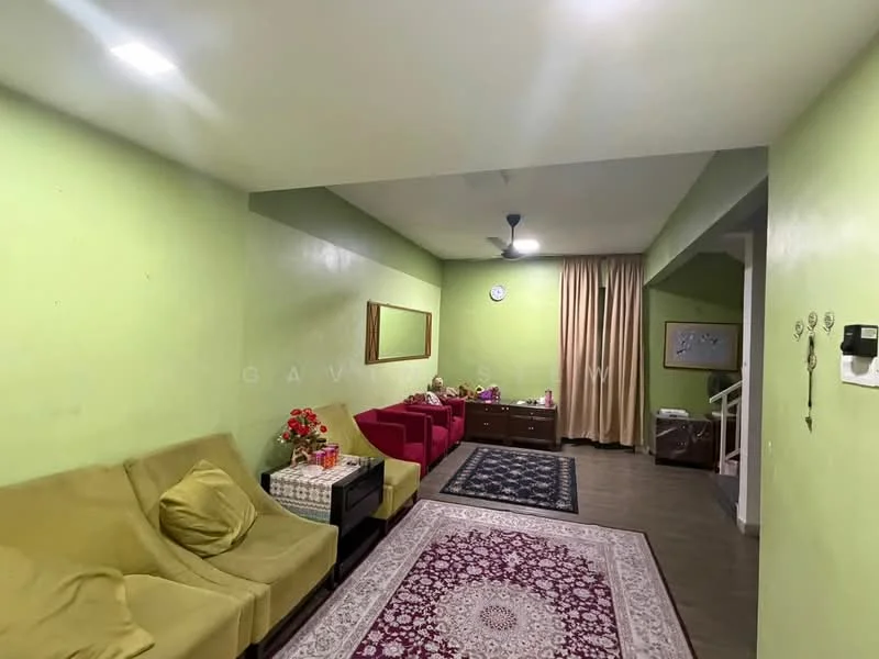 Living features: green painted walls, laminate flooring, 5-blade ceiling fan, recessed downlights, sofa in beige fabric, 2 red accent chairs, coffee table, decorative area rug with intricate pattern, framed mirror on wall, curtains in beige, wall clock, decorative items on furniture; style: modern.