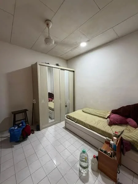 Bedroom features: white painted walls, dropped ceiling, white tiled flooring, queen-size bed with beige bedding, upholstered headboard, built-in wardrobe with mirrored doors, wooden stool, decorative pillows in pink, plastic water bottle, small bedside table with items.