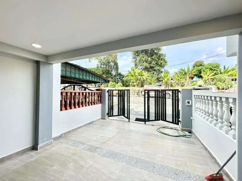Exterior features: tiled flooring, white painted walls, black metal gate, balustrade with white columns, manicured garden view, covered roof, outdoor space, landscaped area with greenery; style: modern.