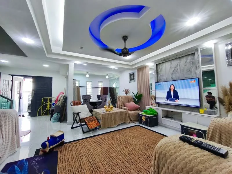 Living features: white painted walls, polished tile flooring, tray ceiling with blue LED lighting, 5-blade ceiling fan with light, wall-mounted TV, entertainment unit, area rug with natural fibers, decorative plants, sofa with throw blankets, coffee table, decorative wall art, sliding glass door, open layout to dining area; style: modern.