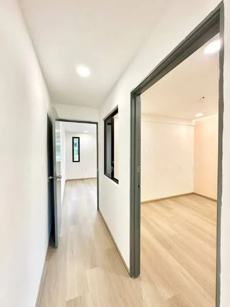 Room features: white painted walls, light wood laminate flooring, recessed downlights, doorway leading to another room, window with black frame, neutral wall color, open layout, no visible furniture; style: modern.