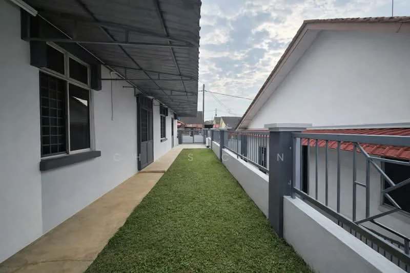Exterior type: linked terrace house; features: manicured lawn, concrete pathway, metal railing, gabled roof, grey painted facade, overhanging roof, side yard, adjacent houses visible; style: modern.