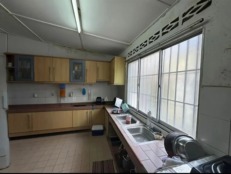Kitchen features: wood cabinetry with upper glass-front cabinets, brown laminate countertop, double-bowl stainless-steel sink, chrome pull-down faucet, white tiled backsplash, window with grid pattern, tile flooring, kitchen appliances visible on countertop, open shelving, wall-mounted storage, overhead fluorescent lighting.