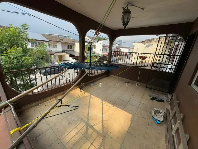 Balcony features: tiled flooring, metal railing, overhead light fixture, clothes drying rack, open view to surrounding houses, decorative wall, sitting area, outdoor space.