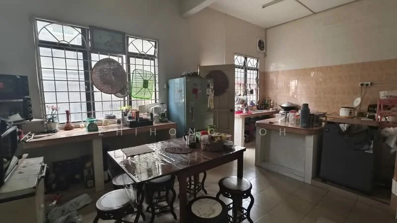 Kitchen features: white tiled walls, cream tiled backsplash, light grey laminate countertops, wooden dining table, 4 wooden stools, stainless-steel fridge, built-in oven, microwave, kitchen cabinets, sink, ceiling fan, floor tiles, window with metal grille, open shelving, various kitchen utensils and appliances.