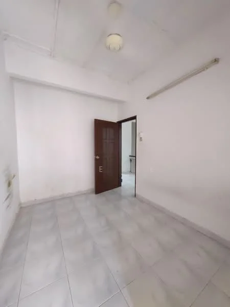 Room features: white painted walls, tile flooring, single wooden door, ceiling light fixture, window with no visible treatment, corner wall with electrical outlets.