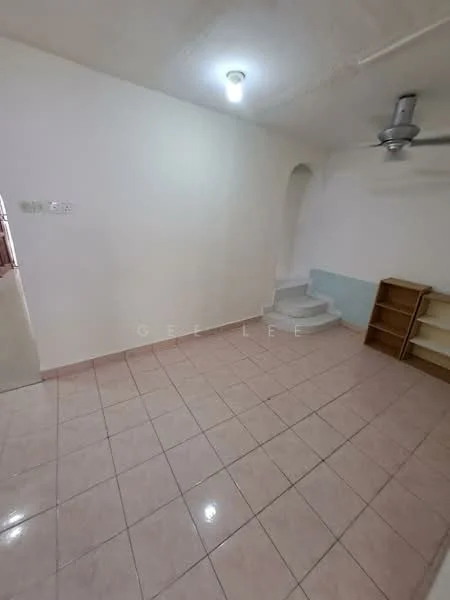 Room features: white painted walls, light-colored tiled flooring, ceiling light fixture, ceiling fan, staircase leading to another level, built-in shelving unit, corner with light green wall paint, no visible windows.