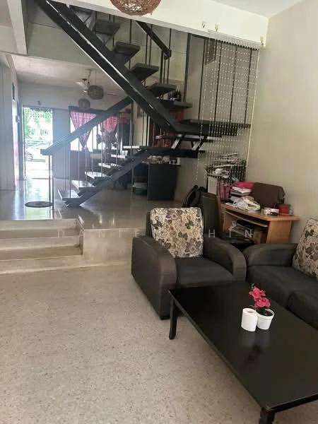 Living features: sofa with floral pattern, black coffee table, decorative flowers in white pots, open staircase with metal railing, light-colored walls, ceiling fan, area rug, natural light from windows; style: modern. Room features: staircase leading to upper floor, dining area visible in background, decorative curtains, furniture in background.