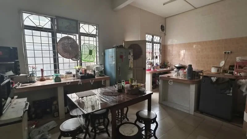 Kitchen features: white tiled walls, cream tiled backsplash, laminate countertop, wooden dining table, 4 wooden stools, stainless-steel fridge, freestanding gas stove, microwave, kitchen sink, open shelving, cabinets with doors, window with metal grilles, ceiling fan, tile flooring.