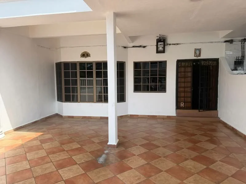 Room features: white painted walls, terracotta tile flooring, large windows with black frames, double doors, exposed ceiling, decorative wall plaque, corner column, open layout.