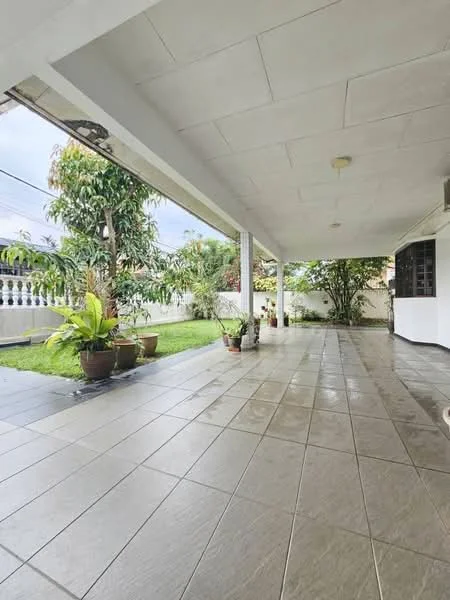 Exterior type: detached bungalow; features: covered patio, grey tiled flooring, manicured lawn, potted plants, white painted walls, exposed ceiling, outdoor space with greenery, fenced perimeter; style: modern.
