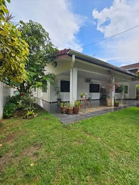 Exterior type: detached bungalow; features: manicured lawn, mature trees, paved walkway, outdoor seating area, air conditioning unit visible, flower pots, greenery surrounding the property; style: modern.
