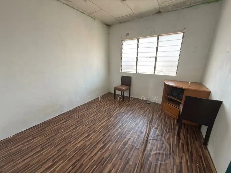 Room features: white painted walls, wooden flooring, single window with horizontal bars, two wooden chairs, wooden cabinet with drawers, bare ceiling, no visible decor; style: minimalist.