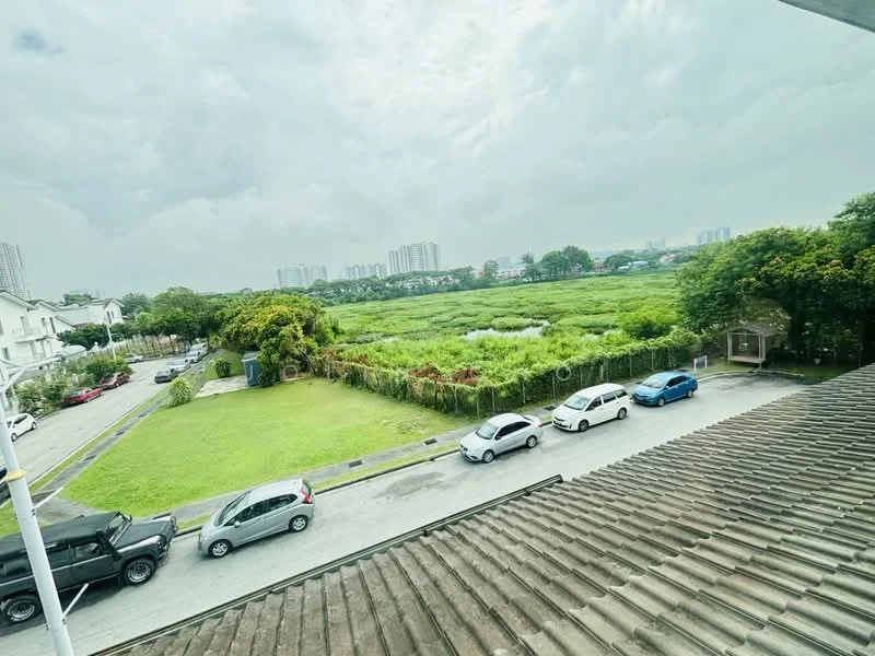 Exterior features: green open field, surrounding residential buildings, paved road, parked cars, trees, cloudy sky.