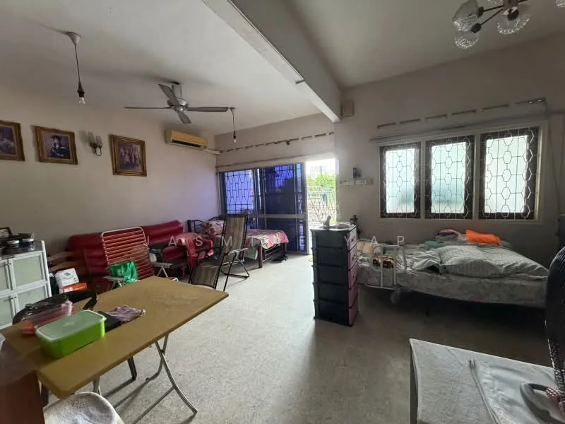 Living features: ceiling fan, wall-mounted air conditioning unit, window with grille, wooden framed windows, light-colored walls, tile flooring, sofa set in red, dining table with chairs, bed with bedding, decorative wall frames, side table, storage cabinet.