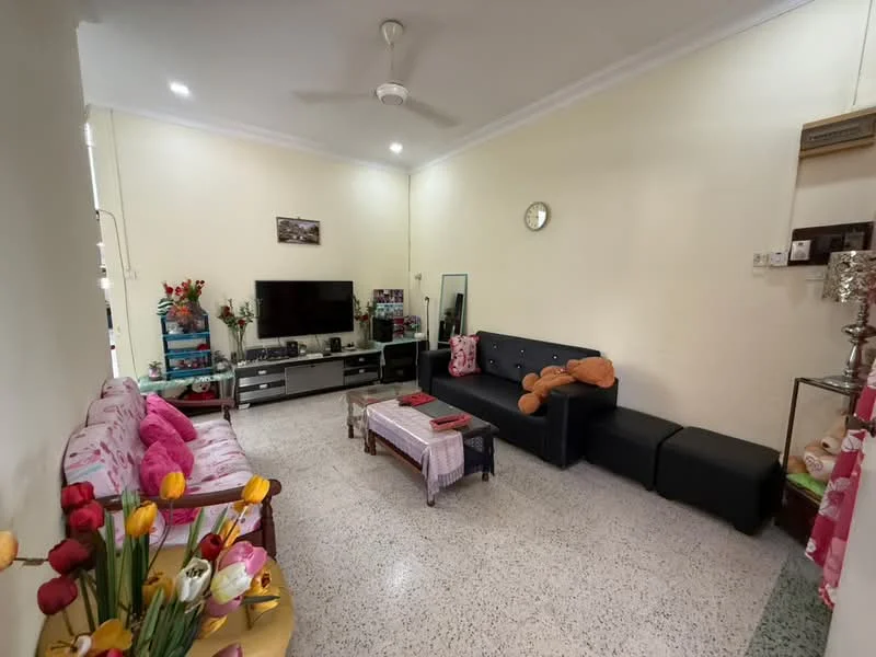 Living features: light-colored painted walls, speckled terrazzo flooring, ceiling fan, wall-mounted TV, black TV console, pink floral sofa, black sectional sofa, coffee table, decorative wall clock, mirror, decorative plants in vases, area rug; style: contemporary.