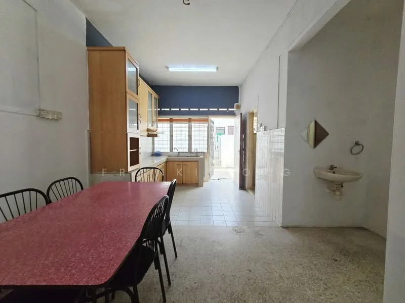 Kitchen features: red laminate dining table, black metal dining chairs, wood cabinetry, white tiled backsplash, single-bowl stainless-steel sink, chrome faucet, window with natural light, tile flooring, exposed concrete wall, light fixture on ceiling.
