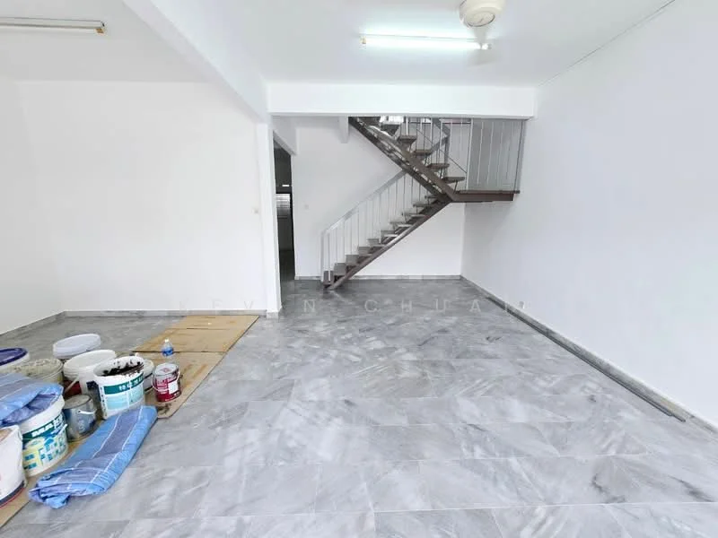 Room features: grey marble tile flooring, white painted walls, staircase with metal railing, ceiling light fixture, open space layout, unfinished area with paint buckets, wooden staircase, large windows for natural light; style: modern.