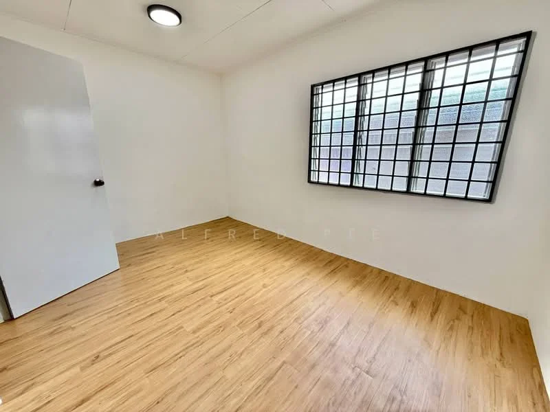 Room features: laminate flooring, white painted walls, black grid windows, ceiling light fixture, single door, no visible furniture; style: minimalist.