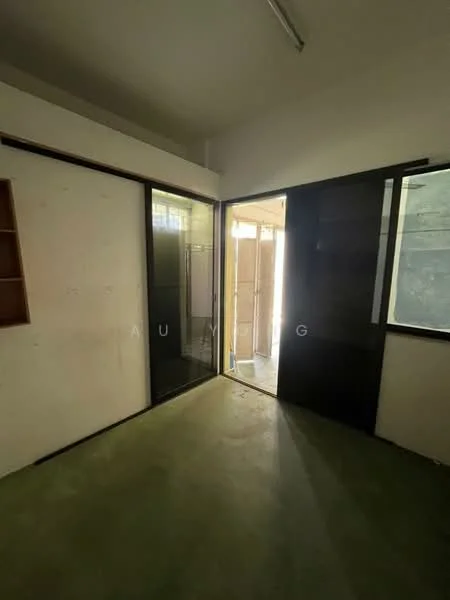 Room features: green concrete flooring, white walls, sliding glass door, large window, built-in shelving, ceiling lights, doorway leading outside.