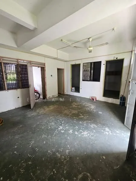 Room features: concrete flooring, white painted walls, exposed ceiling beams, ceiling fan, multiple doorways, windows with metal grilles, unfinished walls, visible electrical outlets.
