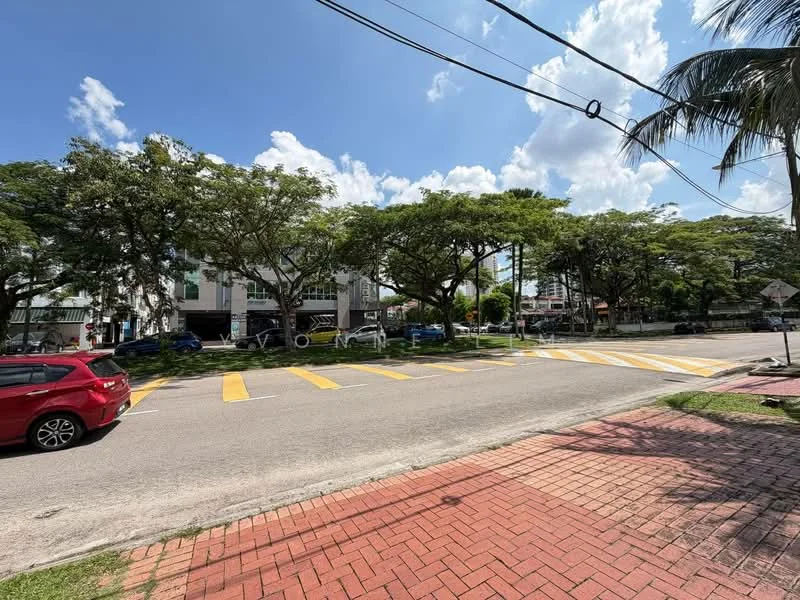 Exterior type: low-rise apartment block; features: manicured lawn, mature trees, paved walkway, street view, parking spaces visible, crosswalk, surrounded by greenery; style: modern.