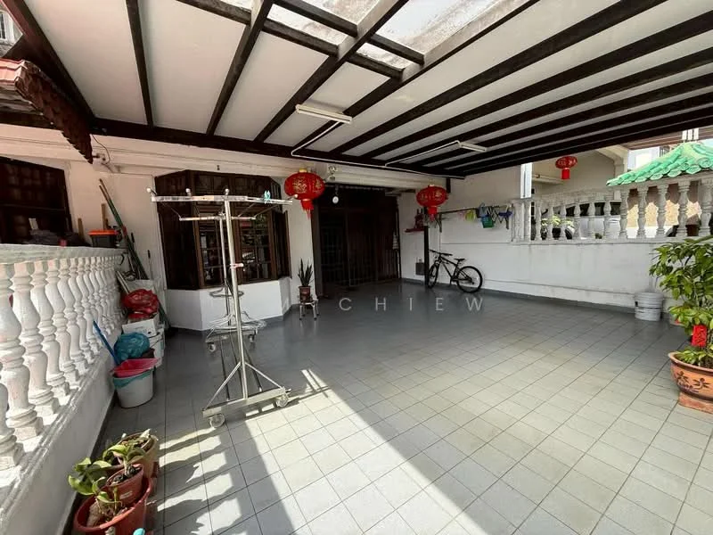 Room features: grey ceramic tile flooring, exposed wooden beams on ceiling, white painted walls, large open space, decorative red lanterns, bicycle, potted plants, white railing, natural light from skylight; style: modern.