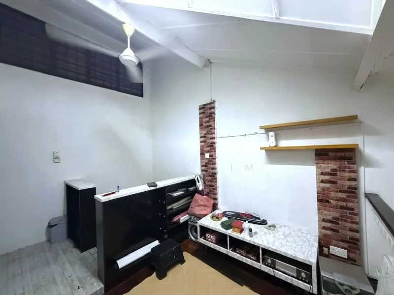 Room features: white painted walls, exposed brick accent wall, wooden flooring, ceiling fan, TV console, shelves, decorative items on shelves, small waste bin; style: modern.