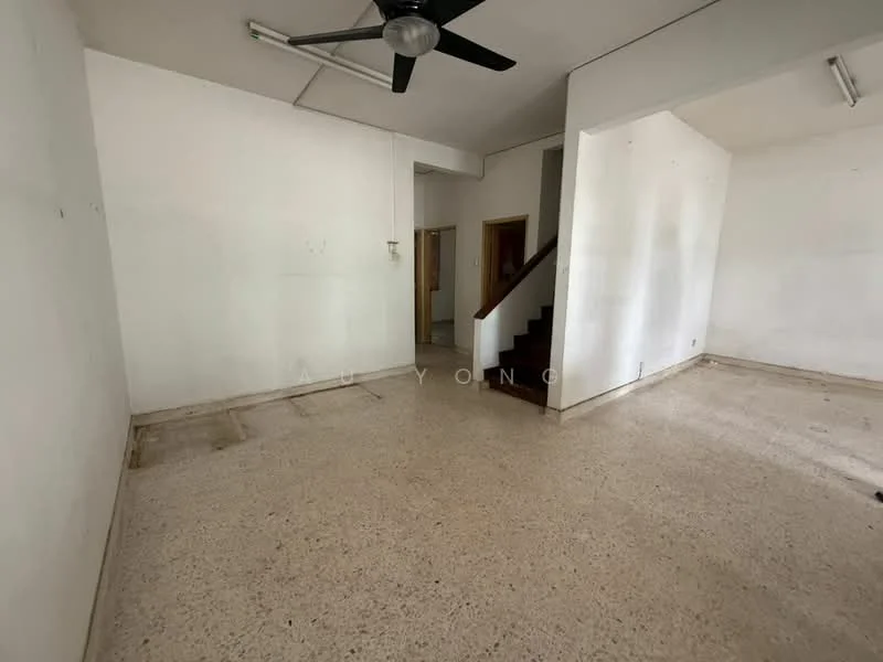 Room features: white painted walls, exposed concrete flooring, ceiling fan, staircase, large open space, natural light from windows, no visible furniture; style: minimalist.