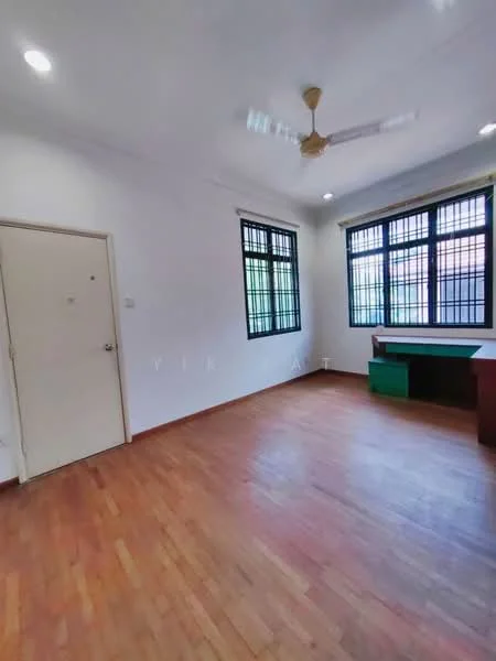 Room features: wooden flooring, white painted walls, ceiling fan, large windows with black frames, green wooden cabinet, desk or table, door, natural light.