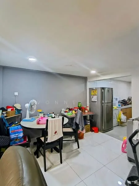 Room features: white painted walls, glossy tile flooring, round dining table, black dining chairs, stainless-steel fridge, kitchen cabinets, various kitchen appliances, ceiling lights, fan, cluttered countertop, colorful storage boxes, laundry items, hanging clothes; style: modern.