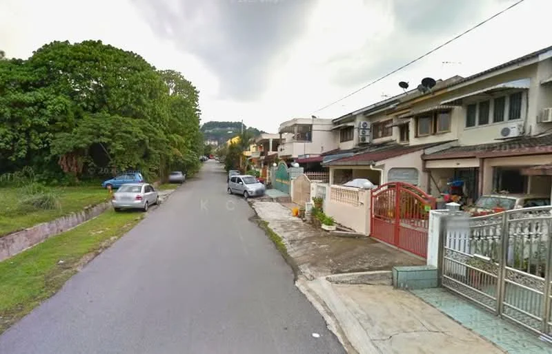 Exterior type: linked terrace house; features: two-storey linked terrace houses, red gate, driveway with interlocking pavers, manicured lawn, mature trees, street view, visible parked cars, sidewalk, front yard; style: modern.