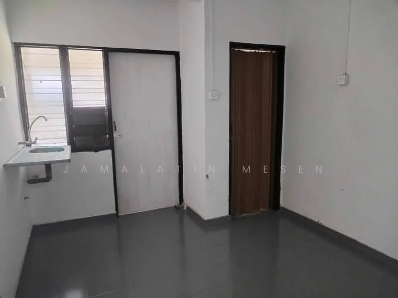 Room features: white painted walls, grey floor tiles, single-bowl stainless-steel sink, window with horizontal slats, white door, brown door, light source from window.