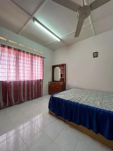 Bedroom features: queen-size bed with blue bedspread, white walls, white tiled flooring, ceiling fan, curtains with floral pattern, wooden dresser with mirror, window with sheer curtains, decorative wall frame.