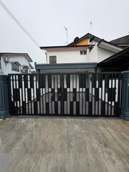 Exterior features: black metal gate, concrete driveway, two-storey residential building, roof with overhang, satellite dish on roof, visible windows, grey wall, surrounding residential area; style: modern.