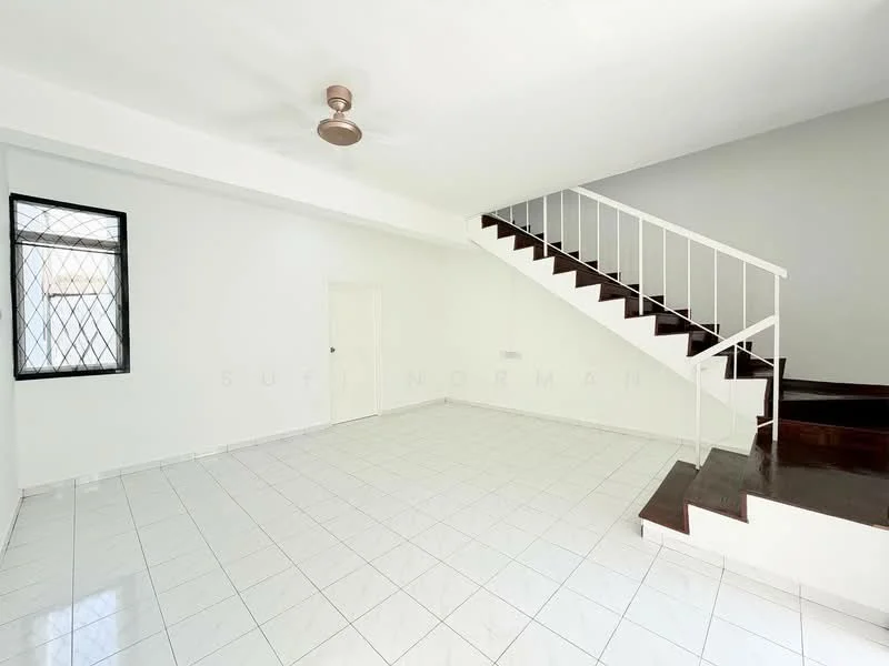 Living features: white painted walls, grey accent wall, white tiled flooring, 5-blade ceiling fan, large window with security grille, staircase with wooden steps, white railing, door leading to unknown room; style: modern.