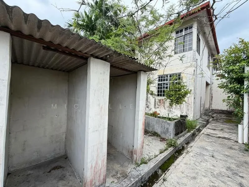 Exterior features: two separate storage units, concrete walls, corrugated metal roof, paved walkway, landscaped area with plants, exterior wall of building with windows, overcast sky.