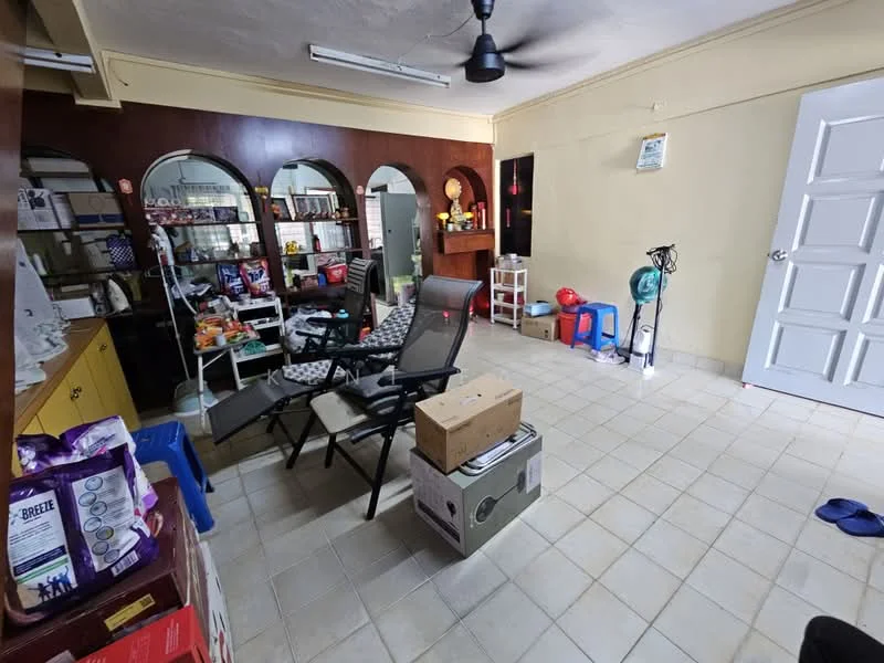 Room features: tiled flooring, cream painted walls, ceiling fan, wooden shelving unit, open shelving, plastic chairs, folding chairs, boxes stacked on the floor, small table, various items on shelves.