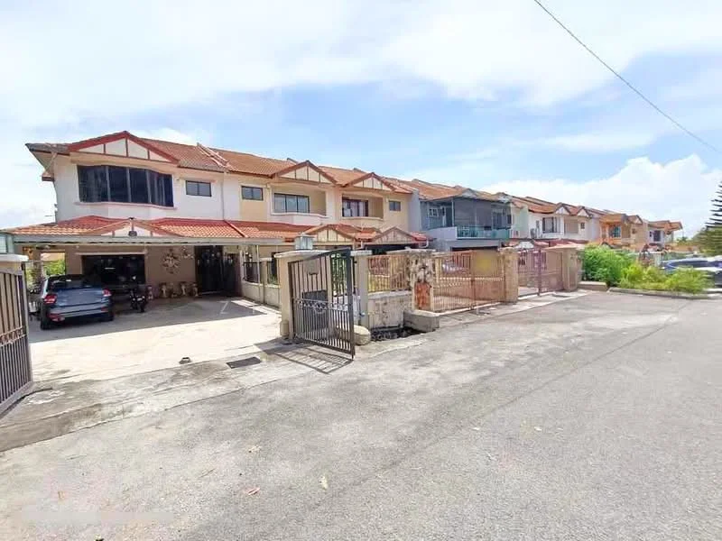Exterior type: linked terrace house; features: two-storey linked terrace houses, red tiled roof, cream painted facade, front gates, driveway with interlocking pavers, manicured lawn, surrounded by greenery, parking space visible, fenced perimeter, street view with clear sky; style: modern.