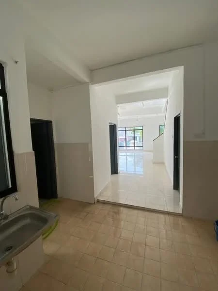 Room features: white painted walls, cream tiled flooring, single-bowl stainless-steel sink, window with black frame, doorway leading to another room, open layout, natural light from windows, high ceiling.
