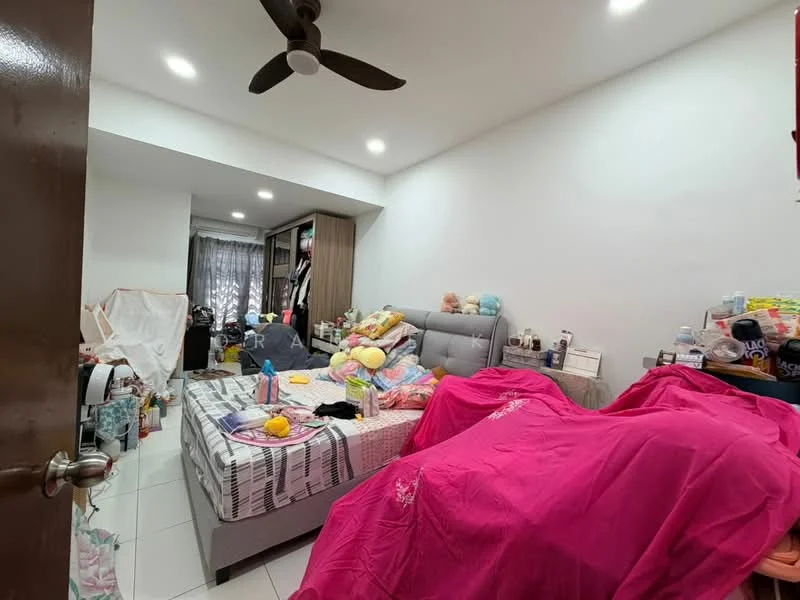 Bedroom features: queen-size bed with upholstered headboard, pink bedspread, white walls, ceiling fan, built-in wardrobe, floor-to-ceiling window with sheer curtains, tile flooring, decorative pillows, various stuffed toys, cluttered bedside table, multiple bottles and containers on surfaces.