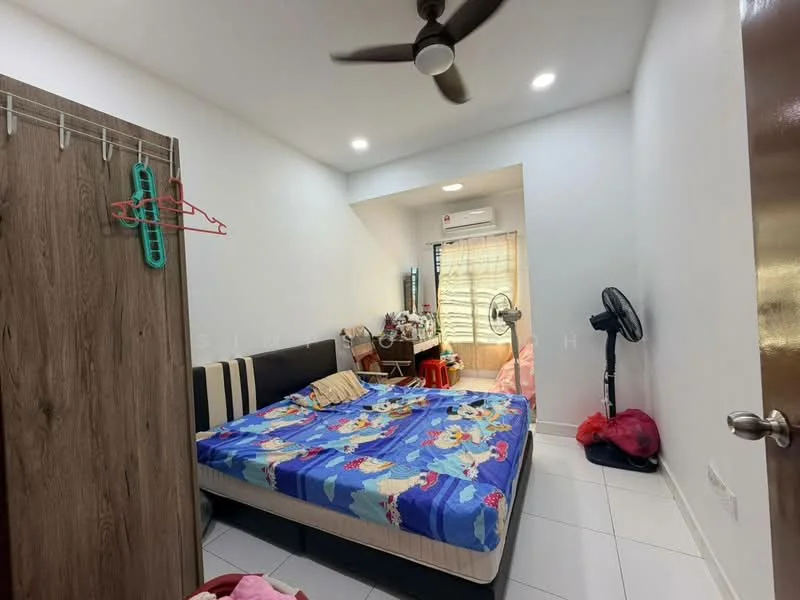 Bedroom features: queen-size bed with colorful bedding, wooden wardrobe, white painted walls, tile flooring, ceiling fan, window with sheer curtains, air conditioning unit, study desk, chair, standing fan, decorative items on desk.
